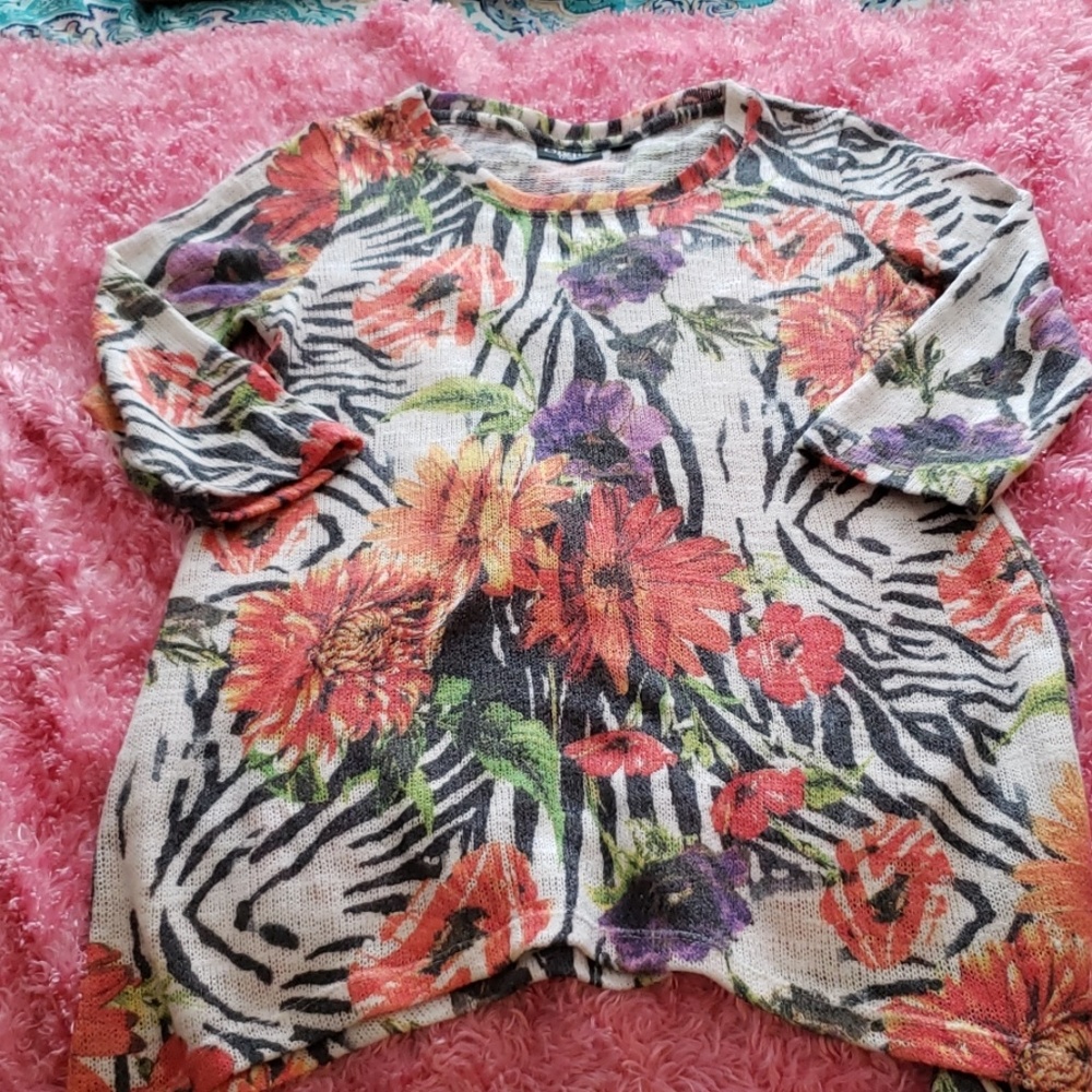 Asymmetrica sweater with animal and palm design